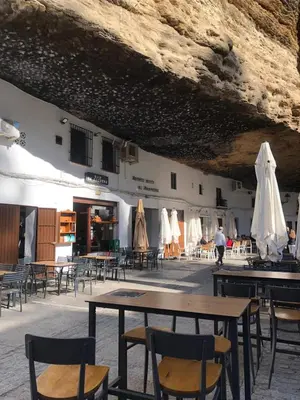 a group of tables and chairs in a building at Villa Stella maison entre Séville et Cadix in Lebrija