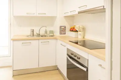 a white kitchen with white cabinets and a sink at Blue Moon House Costa Ballena by Sanlúcar Housing in Costa Ballena