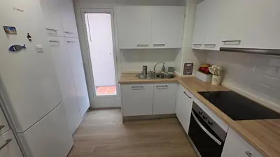 a kitchen with white cabinets and a sink at Blue Moon House Costa Ballena by Sanlúcar Housing in Costa Ballena