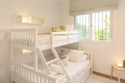 a white bunk bed in a room at Blue Moon House Costa Ballena by Sanlúcar Housing in Costa Ballena