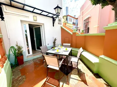 a patio with a table and chairs on a balcony at GATU Coqueto in El Puerto de Santa María