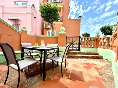 a table and chairs on the balcony of a building at GATU Coqueto in El Puerto de Santa María