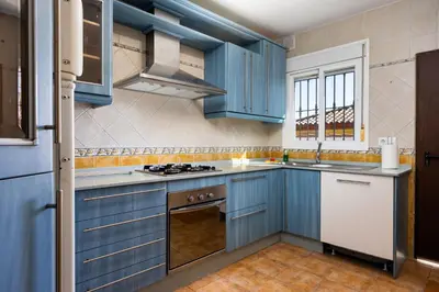a kitchen with a door open to a room at Atlantic Sun Villa - Chiclana in Chiclana de la Frontera