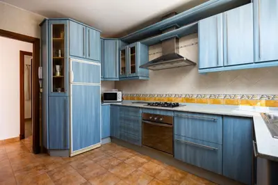 a kitchen with blue cabinets and a sink in it at Atlantic Sun Villa - Chiclana in Chiclana de la Frontera