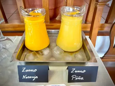 two jars of orange juice on a tray on a table at Hotel Tugasa Villa de Algar in Algar