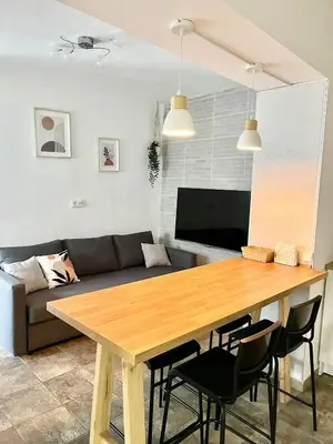 a living room with a wooden table and a couch at Apartamento en El Puerto de Santa María in El Puerto de Santa María