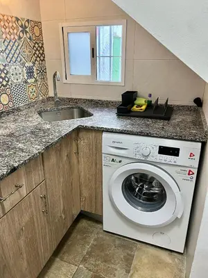 a kitchen with a washing machine and a sink at Apartamento en El Puerto de Santa María in El Puerto de Santa María