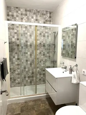 a bathroom with a shower and a toilet and a sink at Apartamento en El Puerto de Santa María in El Puerto de Santa María