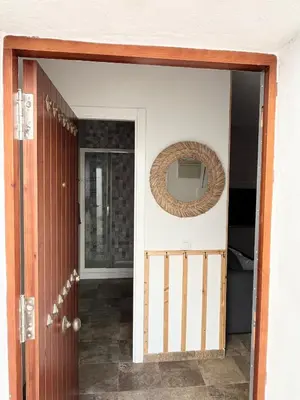 an open door with a mirror on a wall at Apartamento en El Puerto de Santa María in El Puerto de Santa María