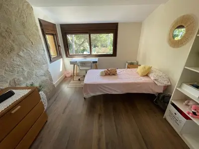 a bedroom with a bed and a desk in a room at Casa Savile in Novo Sancti Petri