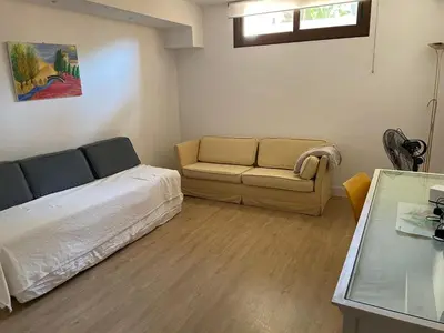 a bedroom with a bed and a couch and a table at Casa Savile in Novo Sancti Petri