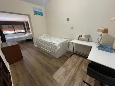 a small room with two beds and a desk at Casa Savile in Novo Sancti Petri