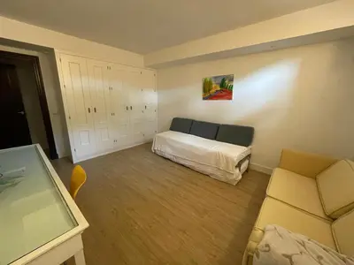 a bedroom with a bed and a couch in it at Casa Savile in Novo Sancti Petri