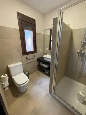a bathroom with a toilet and a shower and a sink at Casa Savile in Novo Sancti Petri