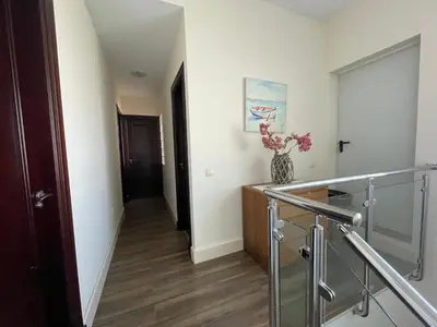 a hallway with a staircase and a vase of flowers at Casa Savile in Novo Sancti Petri