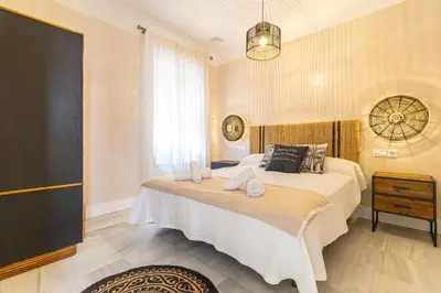 a bedroom with a bed with towels on it at La Casa de la Plaza del Arroyo - Traditional Luxury in Jerez in Jerez de la Frontera