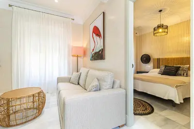a living room with a couch and a bed at La Casa de la Plaza del Arroyo - Traditional Luxury in Jerez in Jerez de la Frontera