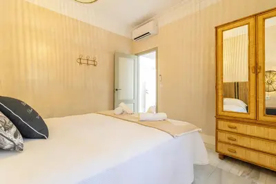 a bedroom with a bed and a mirror at La Casa de la Plaza del Arroyo - Traditional Luxury in Jerez in Jerez de la Frontera