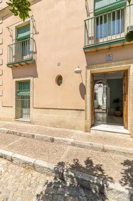 an entrance to a building with a door and balcony at La Casa de la Plaza del Arroyo - Traditional Luxury in Jerez in Jerez de la Frontera