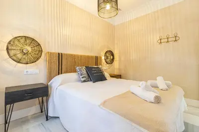 a bedroom with two beds with towels on them at La Casa de la Plaza del Arroyo - Traditional Luxury in Jerez in Jerez de la Frontera