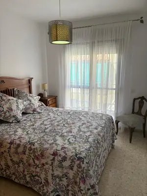 a bedroom with a bed and a window at Brisas de Las Piletas in Sanlúcar de Barrameda