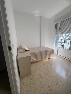 a room with a bed and a box in it at Brisas de Las Piletas in Sanlúcar de Barrameda