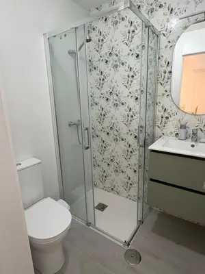 a bathroom with a shower with a toilet and a sink at Brisas de Las Piletas in Sanlúcar de Barrameda