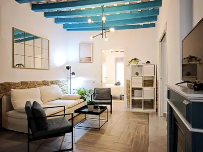 a living room with a white couch and blue ceilings at El Tesoro de Cadiz in Cádiz