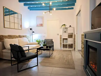 a living room with a couch and a fireplace at El Tesoro de Cadiz in Cádiz