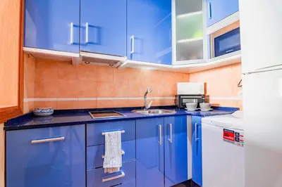 a blue kitchen with a sink and blue cabinets at Edomus Playa de la Costilla in Rota