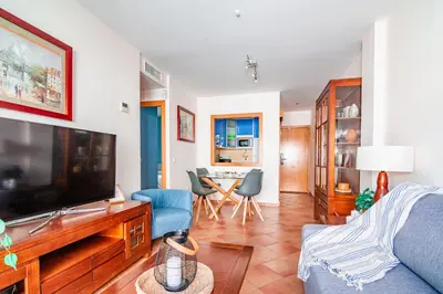 a living room with a large flat screen tv at Edomus Playa de la Costilla in Rota