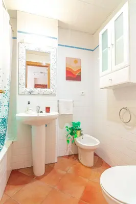 a bathroom with a sink and a toilet at Edomus Playa de la Costilla in Rota