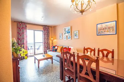 a living room with a couch and a table and chairs at Edomus Faro de Rota in Rota
