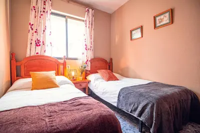 a bedroom with two beds and a window at Edomus Faro de Rota in Rota
