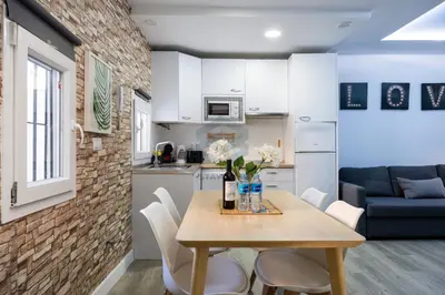 a kitchen and dining room with a table and chairs at La Terraza by Staycare in Rota