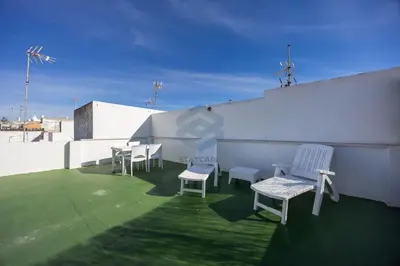 a group of chairs and tables on a roof at La Terraza by Staycare in Rota