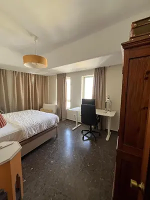 a bedroom with a bed and a desk with a computer at Brand new apartment in the heart of Jerez! in Jerez de la Frontera