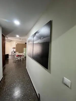 a painting on the wall of a room with a table at Brand new apartment in the heart of Jerez! in Jerez de la Frontera