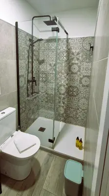 a bathroom with a glass shower and a toilet at Ático de Goleta by Gades Gestión in Cádiz