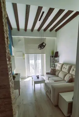 a living room with a couch and a table at Ático de Goleta by Gades Gestión in Cádiz