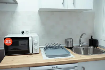 a microwave sitting on a kitchen counter next to a sink at Apartamento SOL Y DUENDE in Jerez de la Frontera