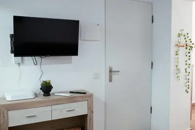 a living room with a television on a wall at Apartamento SOL Y DUENDE in Jerez de la Frontera