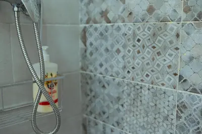 a shower in a bathroom with a tile wall at Apartamento SOL Y DUENDE in Jerez de la Frontera