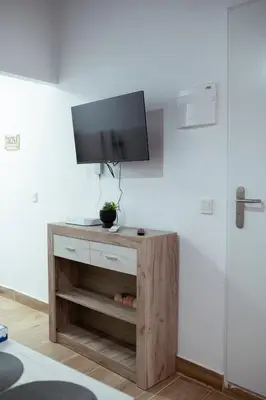 a living room with a tv on a wall at Apartamento SOL Y DUENDE in Jerez de la Frontera