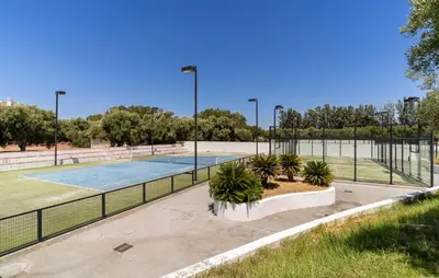a tennis court with palm trees in a park at 2 Bedroom Nice Home In Arcos De La Frontera in Arcos de la Frontera