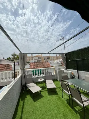a patio with chairs and a table on a roof at Tu ático ideal Terraza, Centro y Playa a pie in Sanlúcar de Barrameda