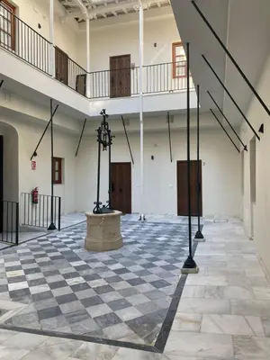 an empty room with a checkered floor and stairs at La Bohéme in Jerez de la Frontera