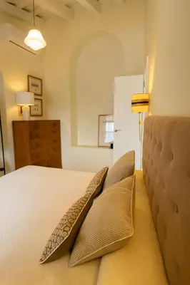a bedroom with a bed with two pillows on it at La Bohéme in Jerez de la Frontera