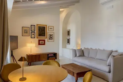 a living room with a couch and a table at La Bohéme in Jerez de la Frontera