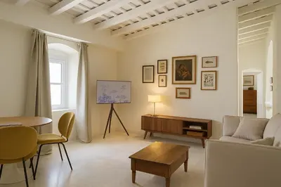 a living room with a couch and a table at La Bohéme in Jerez de la Frontera